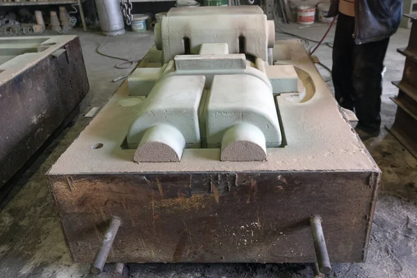 View of the sand mold casting. Sand casting, also known as sand molded  casting, is a metal casting process characterized by using sand as the mold  material. — Photo